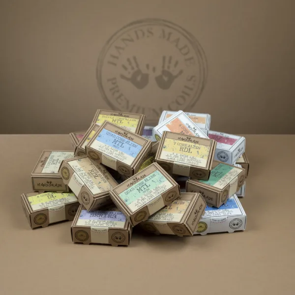 Handsmade Premium Coils packaging boxes on a black surface.